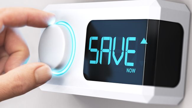Image of someone turning up or down their home thermostat with the word SAVE illuminated